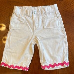 Girls white Bermuda shorts with pink patterned trim and adjustable waist